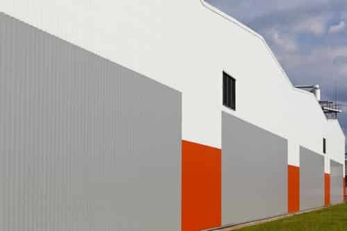 Commercial building envelope where DC 315 intumescent fireproof coating is applied over spray foam insulation